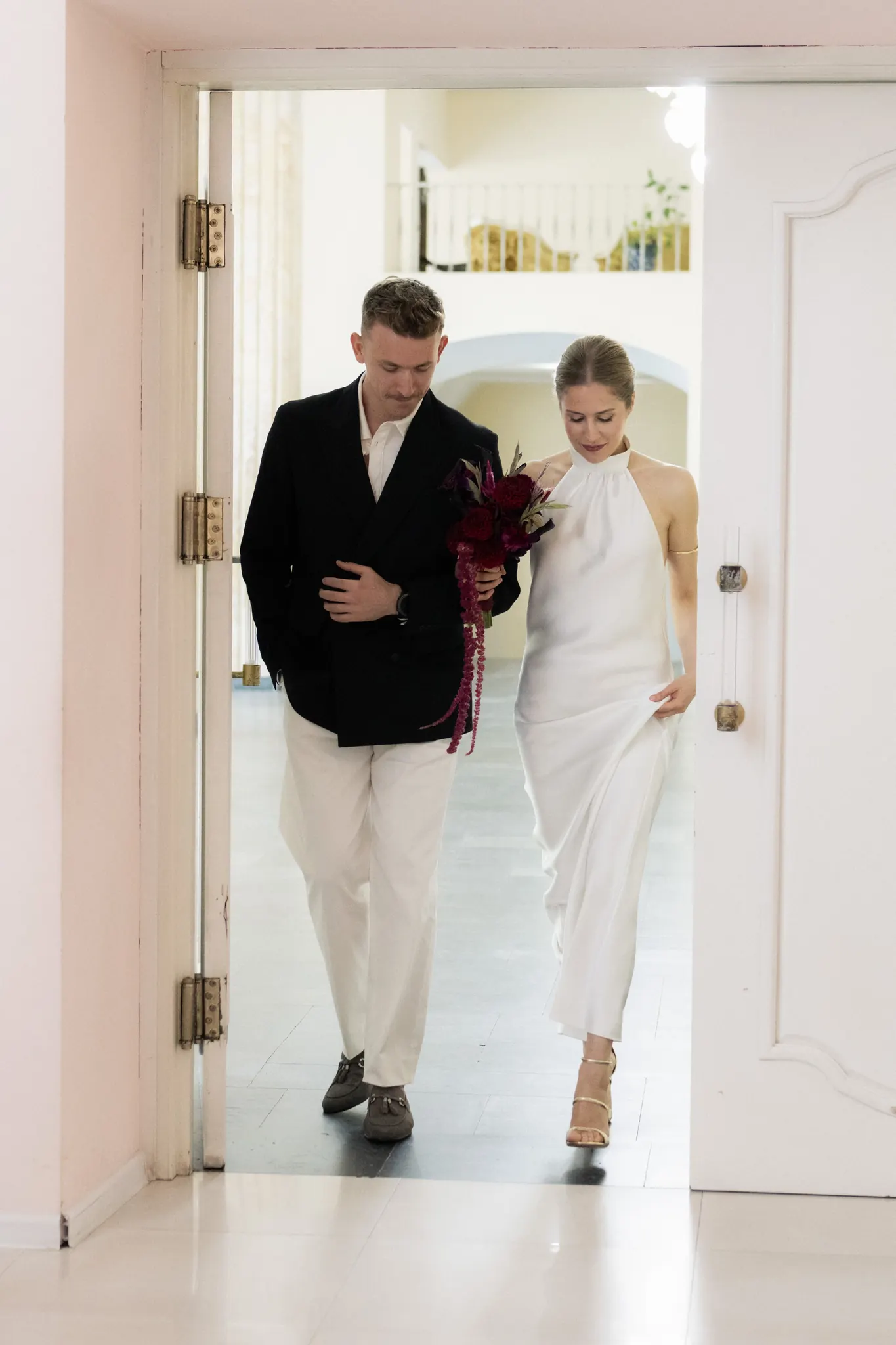Veronika and Sasha walking in through an open door