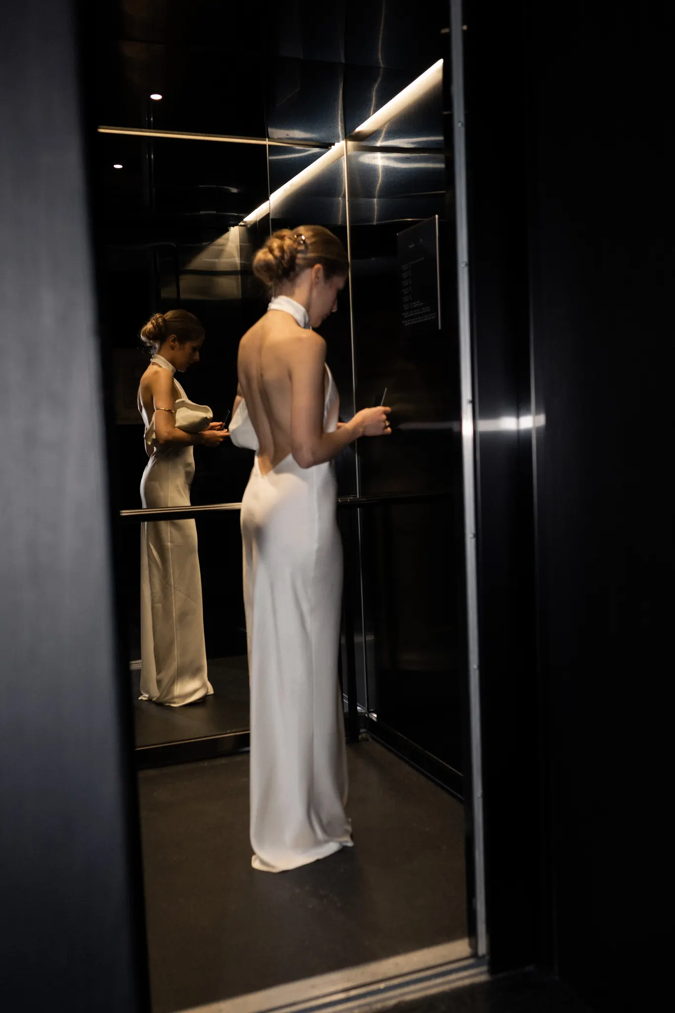 Veronika in an elevator, reflected in the mirrored wall