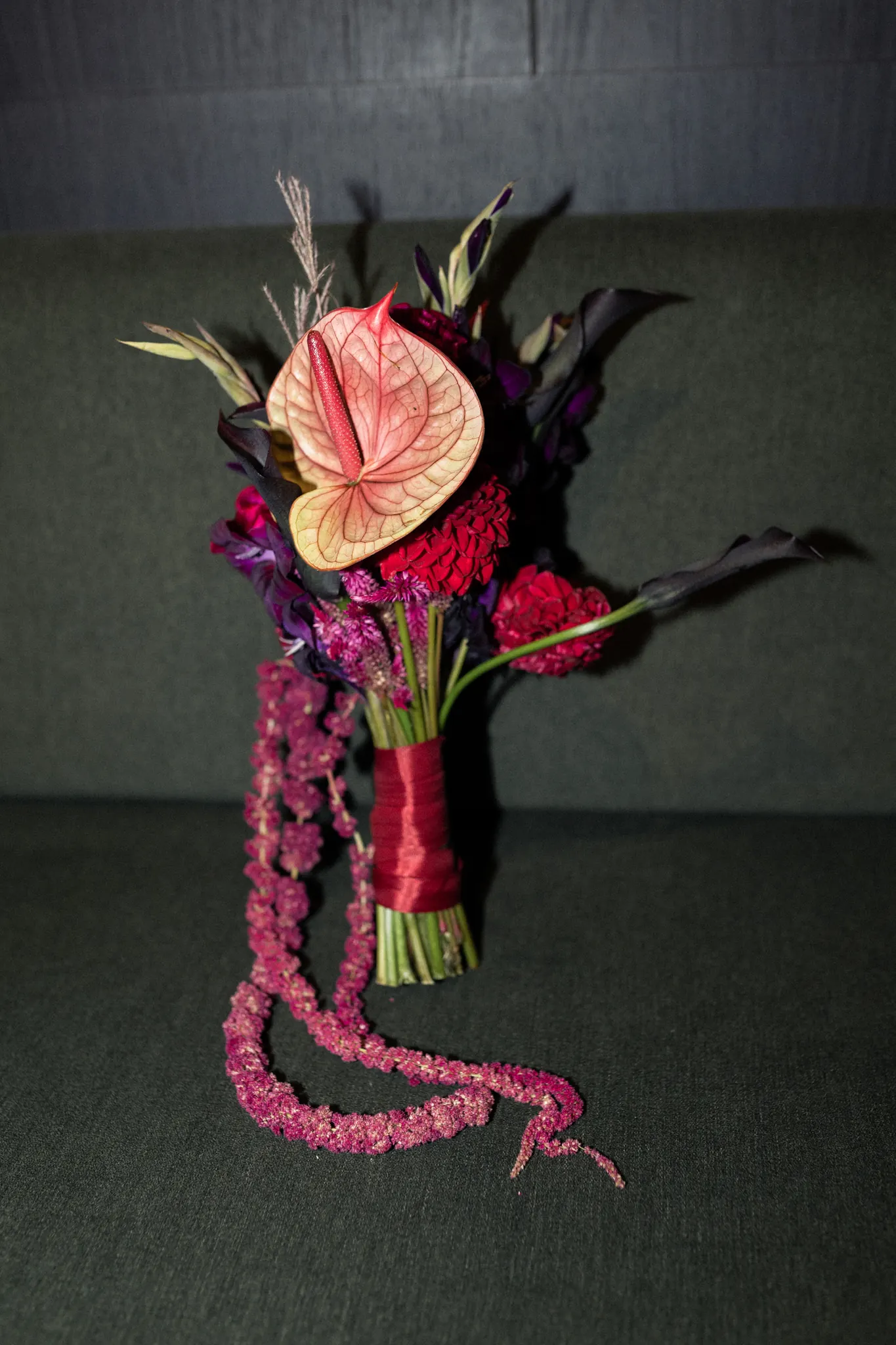 The bouquet resting on a green sofa
