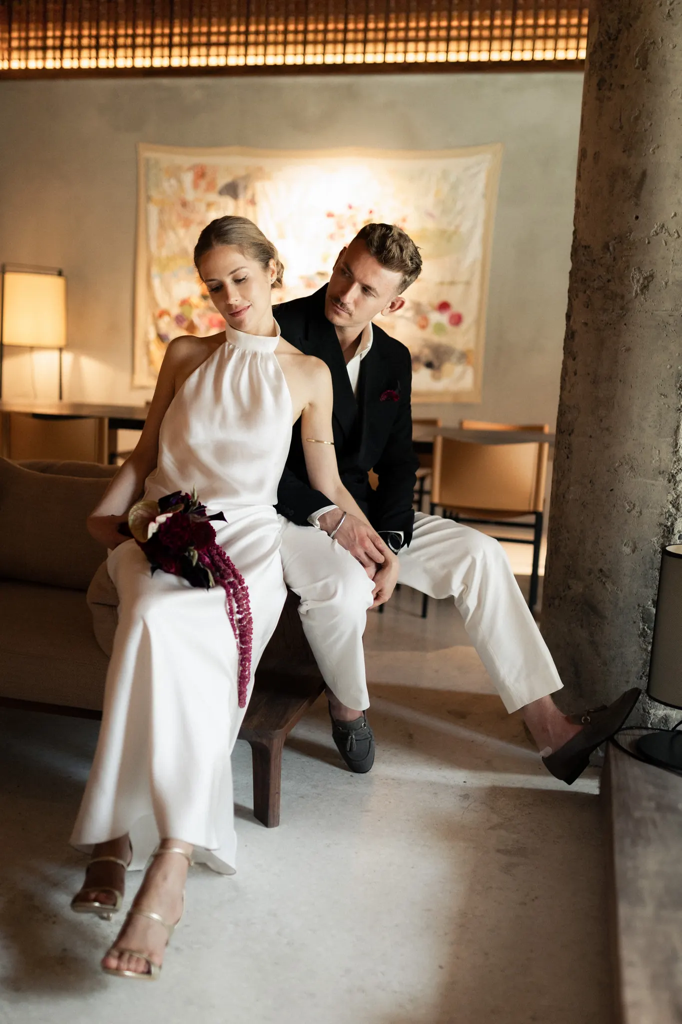 Veronika and Sasha seated beneath a glowing lattice ceiling