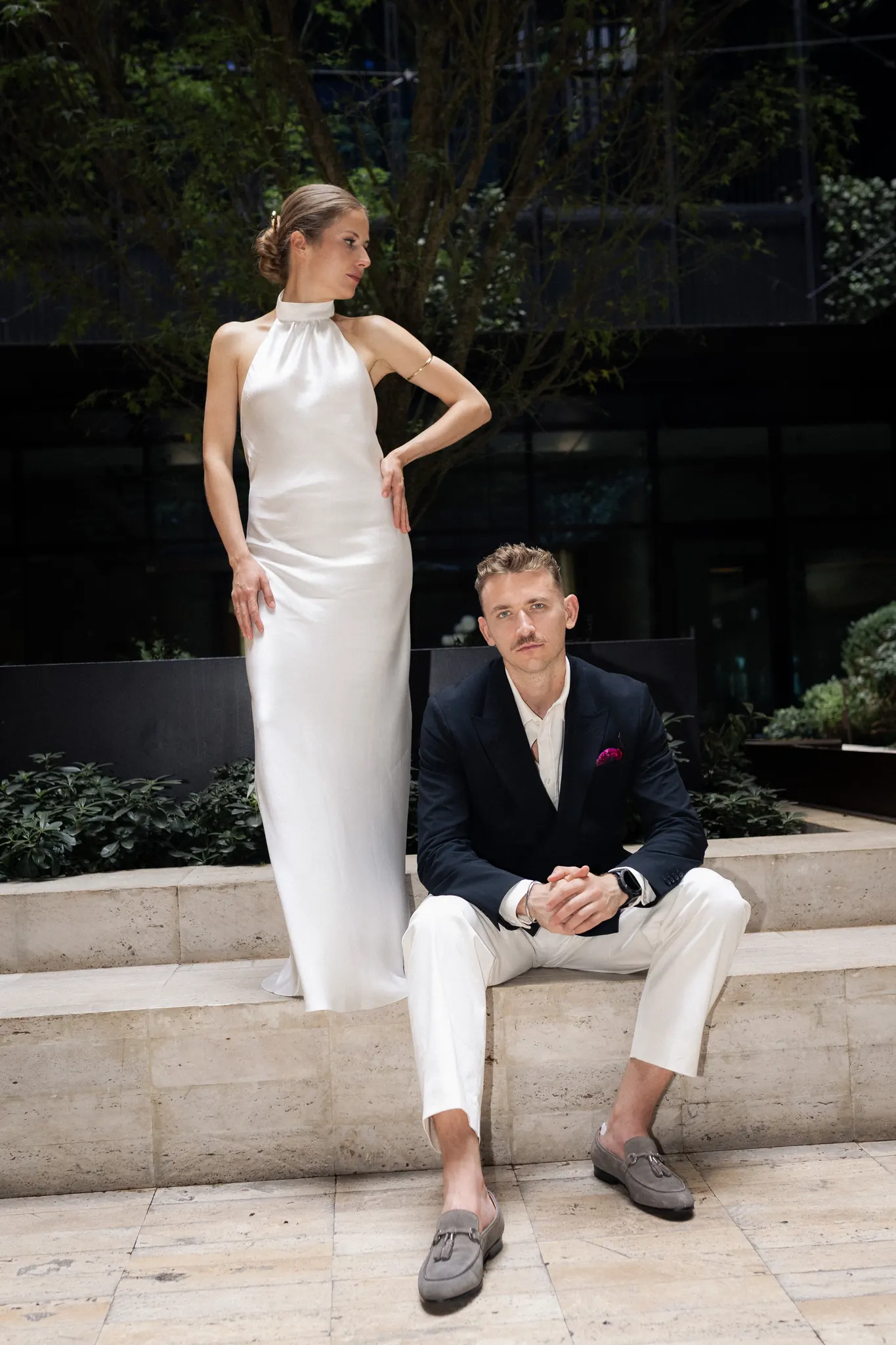 Veronika standing on a stone step with Sasha seated below