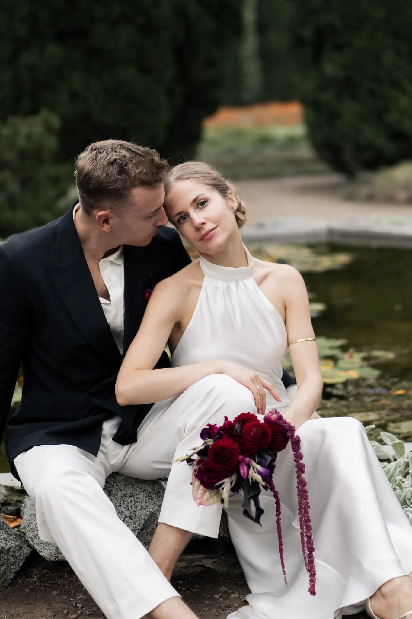 Veronika and Sasha sitting by a lily pond