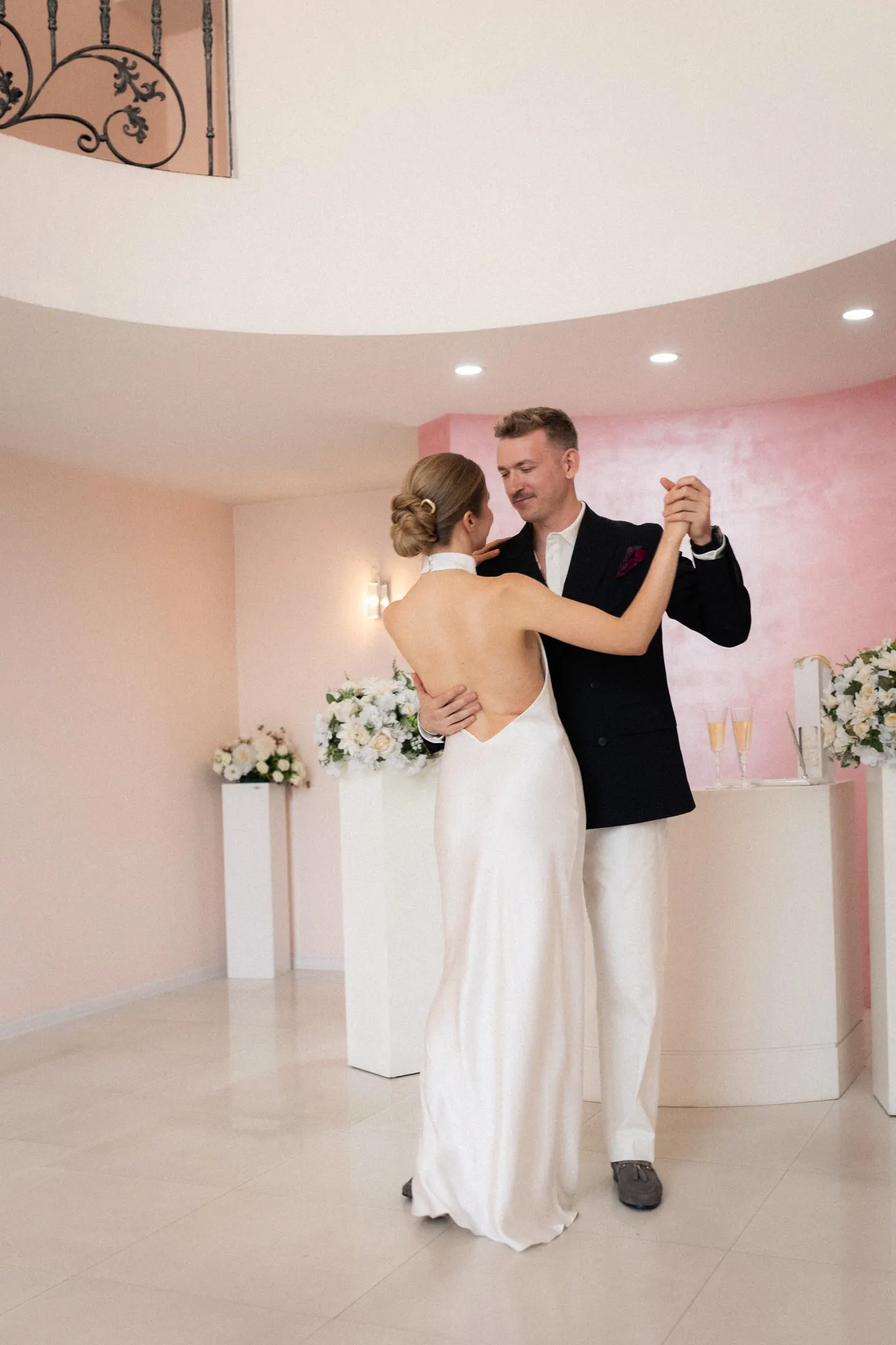 Their first dance in the pink ceremony hall